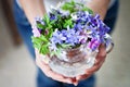 Young girl, holding vase with fresh spring flowers Royalty Free Stock Photo
