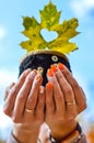 Young girl holding a warm cup with leaf Royalty Free Stock Photo