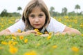 Girl Layng in Field of Yellow Flowers