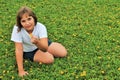 Girl Sitting in Field of Yellow Flowers Royalty Free Stock Photo