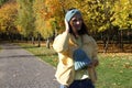 A young girl holds a fashionable knitted hat in her hands. Girl in a knitted bandage. Fashion autumn-winter. Knitted