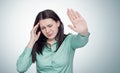 Young girl holds her hand over her head, headache concept