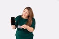 A young girl holds mock up smartphone for shopping app and a credit card. Amazed businesswoman, large woman, online cash Royalty Free Stock Photo