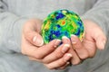 The globe is in your hands. The whole world is in your hands. A young girl holds the planet Earth in her hands. World environment Royalty Free Stock Photo