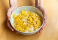 Young girl holds plate with milk and corn flakes Royalty Free Stock Photo