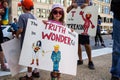 A Young Child Holds a Protest Sign at a Demonstration Against President Donald Trump