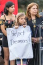 A young girl holds a sign that reads Protect Dreamers