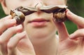 Young girl holds two snails which turn to one to one.