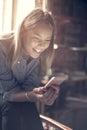 Young girl at home reading funny messages.