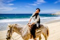 Young girl horseback riding on the beach in Cabo san Lucas, Baja California