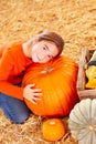 Young Girl Hugging a Big Pumpkin at the Pumpkin Patch Royalty Free Stock Photo