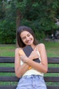 Young girl is hugging her favourite textbook in the park