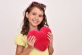 Young girl hugging plush red heart Royalty Free Stock Photo