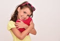 Young girl hugging plush red heart Royalty Free Stock Photo