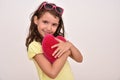 Young girl hugging plush red heart Royalty Free Stock Photo