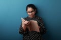 Young girl of Indian origin reading a note book Royalty Free Stock Photo