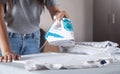 Young girl ironing shirt in home Royalty Free Stock Photo