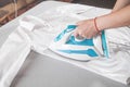 Young girl ironing shirt in home Royalty Free Stock Photo