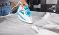 Young girl ironing shirt in home Royalty Free Stock Photo