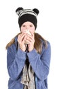 Young girl with jacket and wooly hat holding cup