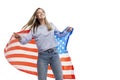 A young girl in jeans and a blue tank top holds an American flag and laughs. Celebrating Independence Day and patriotism. Isolated