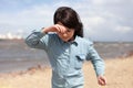 Young girl in jeans shirt and glasses on the seashore Royalty Free Stock Photo