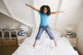 Young Girl Jumping On Her Bed Royalty Free Stock Photo