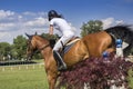 Young girl jumping on horseback