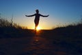 Young Girl Jumping Over Sunset Background. Full Length Silhouette Of A Happy Girl  Running Outdoors. Royalty Free Stock Photo