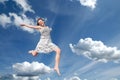 Young girl jumping in sky Royalty Free Stock Photo