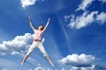 Young girl jumping in sky