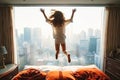 a young girl jumping on the top of her bed Royalty Free Stock Photo