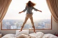 a young girl jumping on the top of her bed Royalty Free Stock Photo