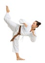 A young girl in a karate pose. Isolated on white background.