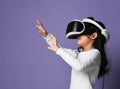 Young girl kid child play virtual reality game hold  vr glasses and surprised. Cyber space and virtual gaming Royalty Free Stock Photo