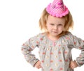 Young girl kid frowns in birthday party pink cap Royalty Free Stock Photo