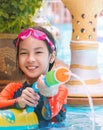 Young girl kid is playing with water gun in a tropical resort in Thailand Royalty Free Stock Photo