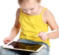 Young girl kid sitting reading learning drawing on digital tablet touch screen pad with pencil Royalty Free Stock Photo