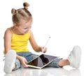 Young girl kid sitting reading learning drawing on digital tablet touch screen pad with pencil Royalty Free Stock Photo