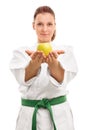 Young girl in kimono offering an apple Royalty Free Stock Photo