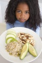 Young girl in kitchen eating rice fruit and nuts Royalty Free Stock Photo