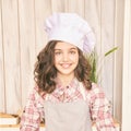 Young girl at kitchen. Little cook chef. Cute female portrait. Baker smile Royalty Free Stock Photo