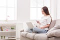 Young girl with a laptop messaging on mobile Royalty Free Stock Photo