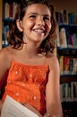 Young girl laughing in a library