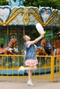 Young girl laughs with cotton candy on a sunny day at an amusement park Royalty Free Stock Photo