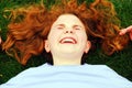 A young girl laughs while laying on the grass Royalty Free Stock Photo