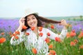 Young woman is in the lavender field with red poppy flowers, beautiful summer landscape Royalty Free Stock Photo