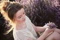 Young girl in the lavender fields with bouquet of flowers Royalty Free Stock Photo