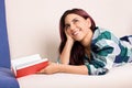 Young girl daydreaming while reading a book Royalty Free Stock Photo