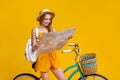 Young Girl Leaning On Bike And Holding City Map In Hands